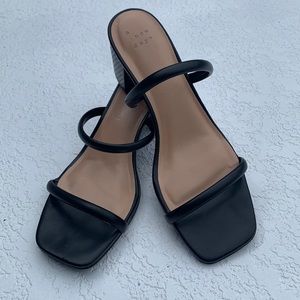 Black strappy sandals with platform heel.